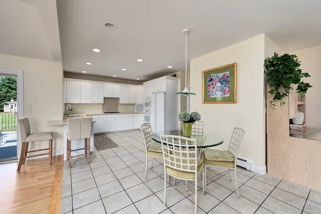 a living room with furniture and a kitchen view