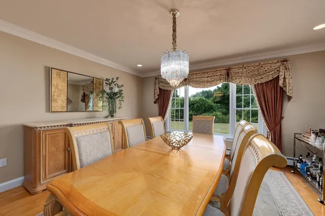 a living room with furniture a flat screen tv and a large window
