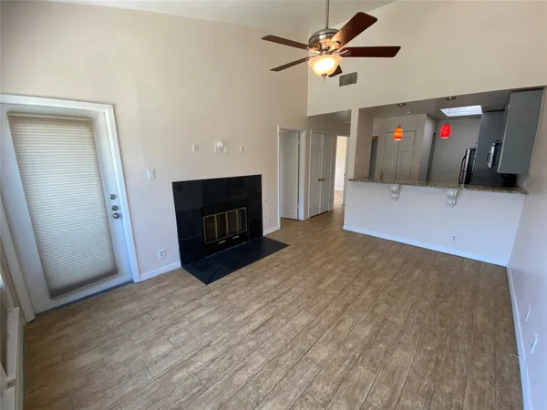 a view of an empty room with a fireplace