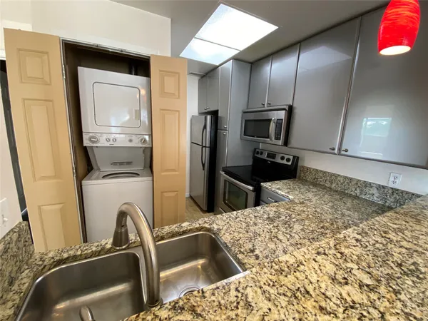 a kitchen with a refrigerator sink and stove