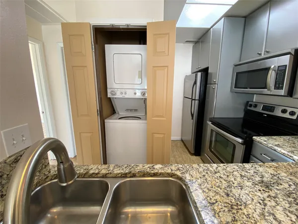 a kitchen with a refrigerator and a sink