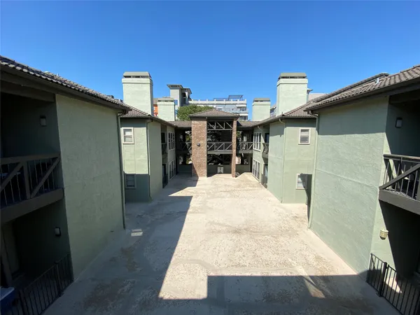 a pathway of a house with yard