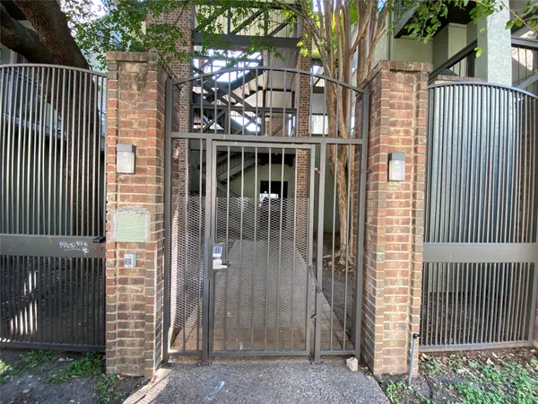 a view of a house with a small yard and wooden fence and floor