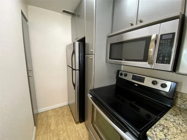 a kitchen with a stove microwave and refrigerator