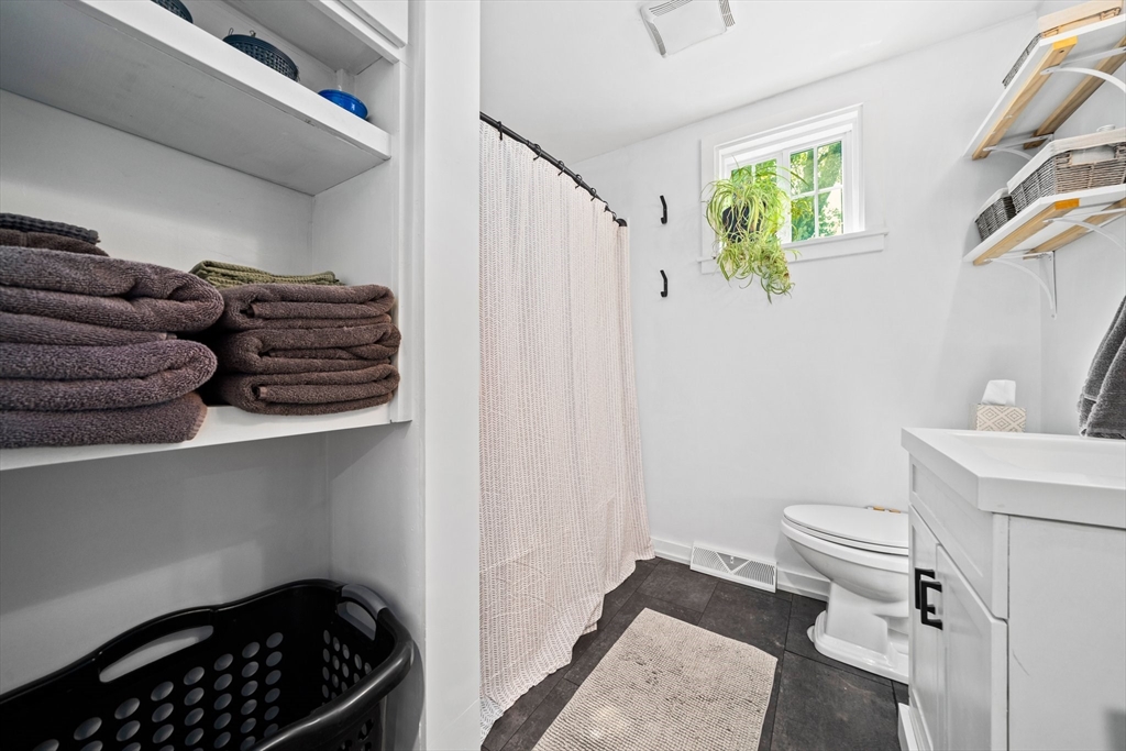 214 Wareham Street Middleboro, MA 02346 - Photo 18 of 37 a bathroom with a granite countertop sink and a toilet
