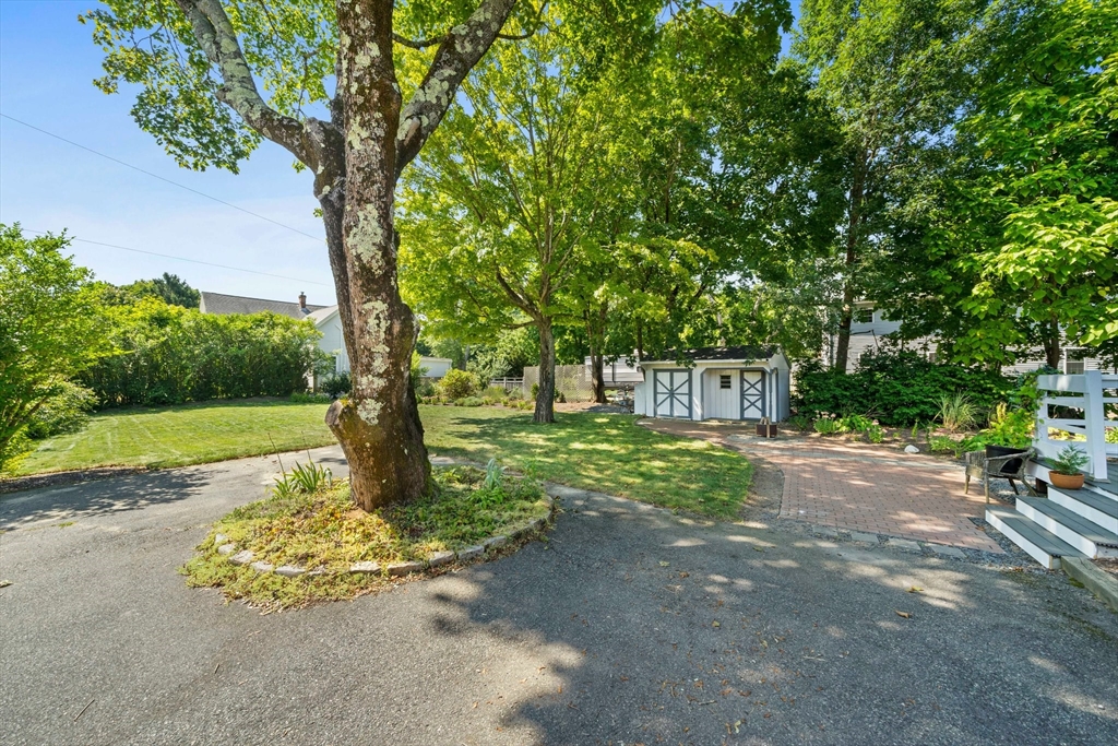 214 Wareham Street Middleboro, MA 02346 - Photo 29 of 37 a garden with trees in front of it