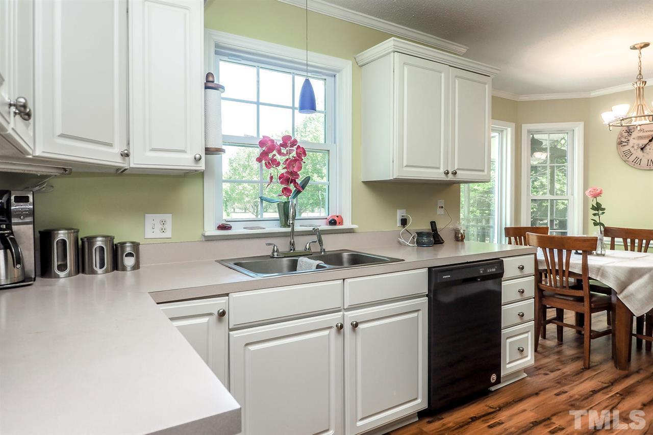 1020 Pagan Road Raleigh, NC 27603 - Photo 11 of 24 a kitchen with stainless steel appliances granite countertop a sink and cabinets
