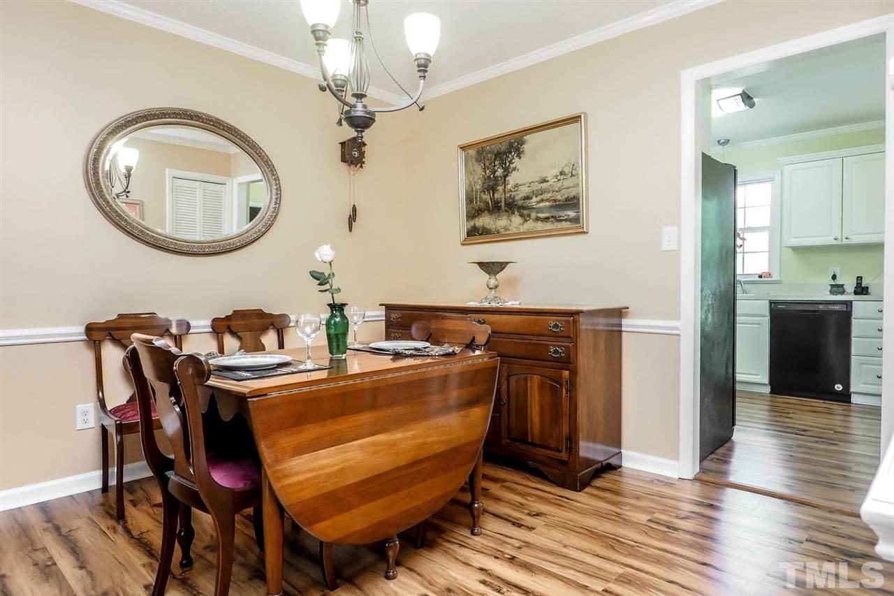 1020 Pagan Road Raleigh, NC 27603 - Photo 14 of 24 a dining room with wooden floor a glass table and chairs