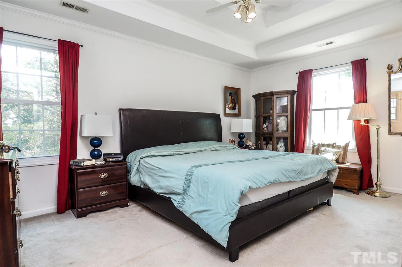 1020 Pagan Road Raleigh, NC 27603 - Photo 17 of 24 a bedroom with a bed and a chandelier
