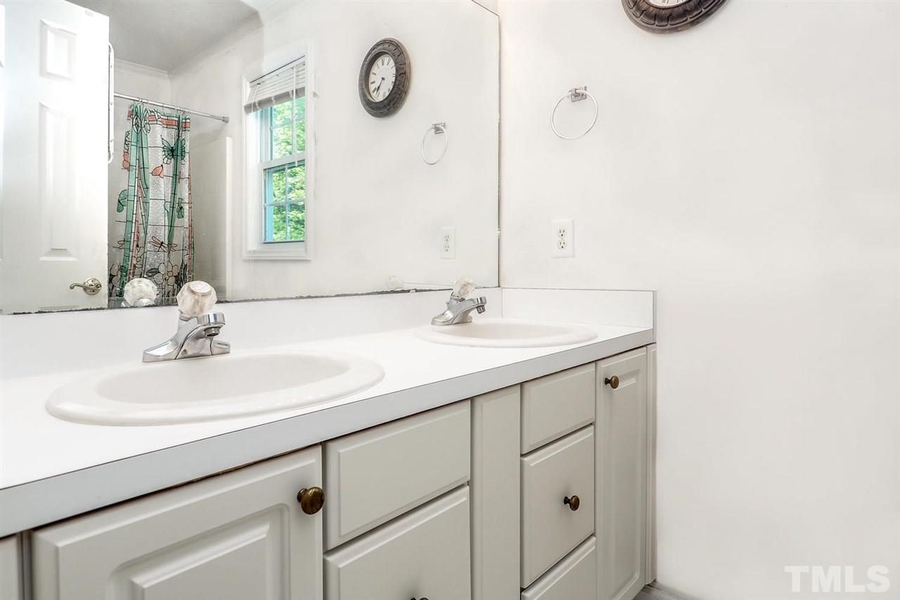 1020 Pagan Road Raleigh, NC 27603 - Photo 18 of 24 a bathroom with a sink and a mirror