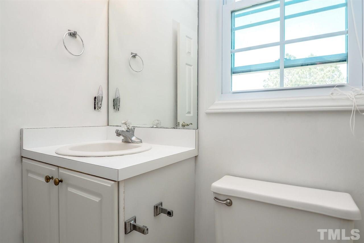 1020 Pagan Road Raleigh, NC 27603 - Photo 19 of 24 a bathroom with a sink a toilet and a mirror