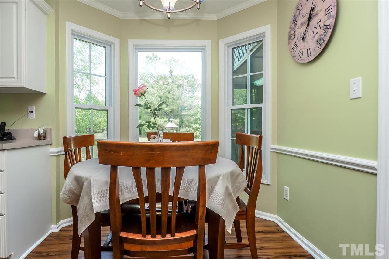 1020 Pagan Road Raleigh, NC 27603 - Photo 8 of 24 a view of a dining room with furniture window and wooden floor