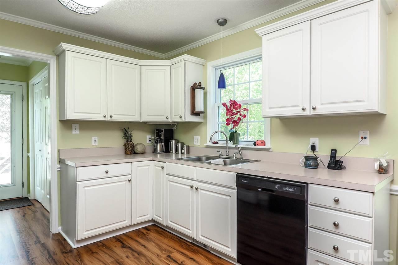 1020 Pagan Road Raleigh, NC 27603 - Photo 10 of 24 a kitchen with white cabinets and white appliances
