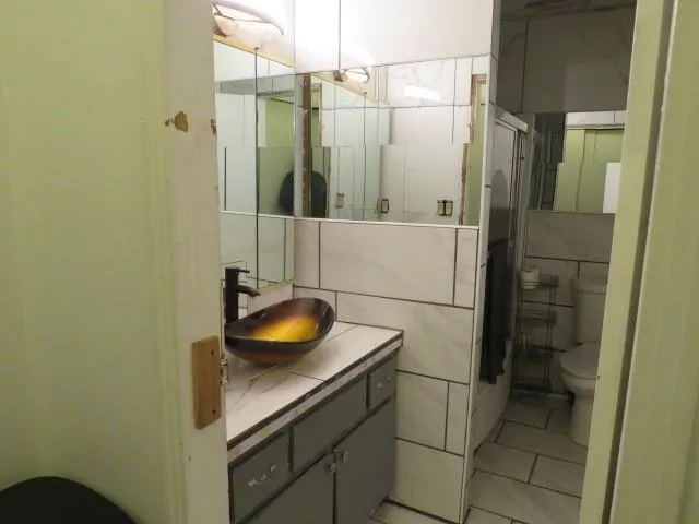 a kitchen with a sink window and cabinets