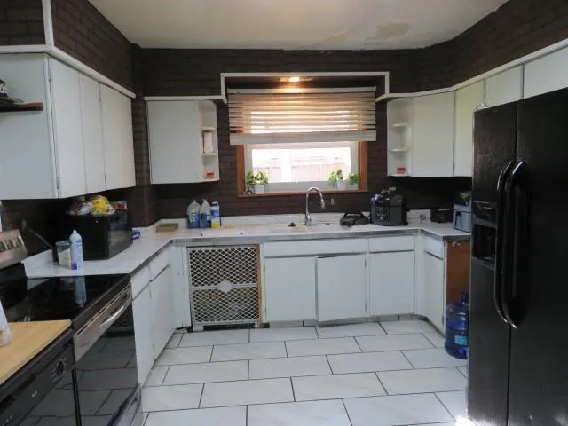 a kitchen with a refrigerator and a cabinets
