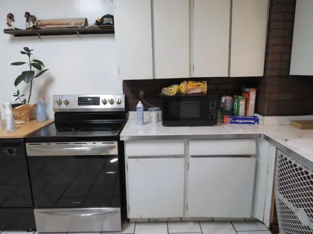 a room with a chair and potted plant
