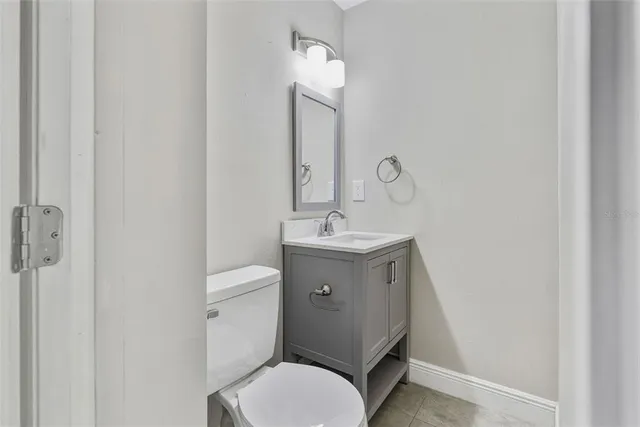 a bathroom with a toilet a sink and mirror