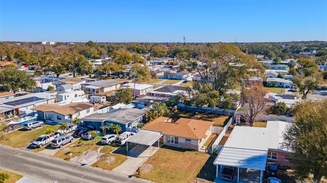 an aerial view of residential houses with city view