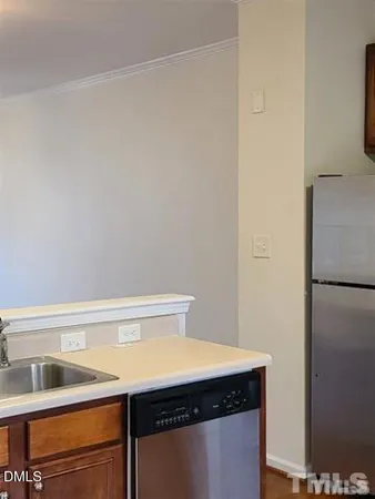a view of a kitchen with a sink and wooden floor
