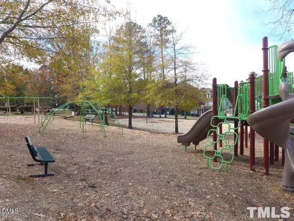 a view of outdoor space with playground and green space
