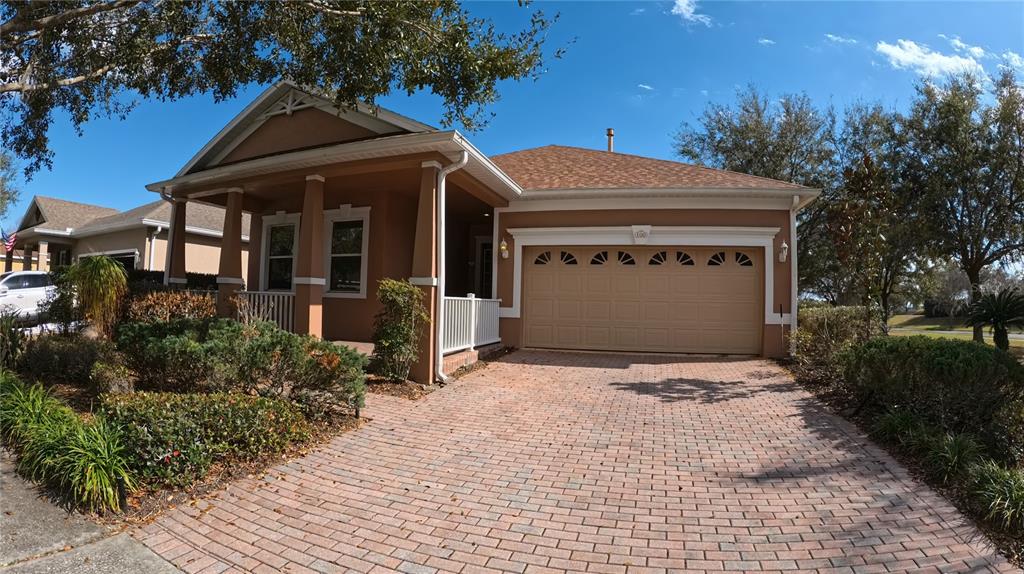 100 Flame Vine Way Groveland, FL 34736 - Photo 1 of 38 a front view of a house with a yard and garage