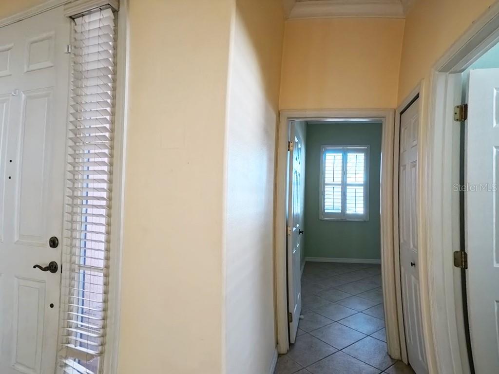 100 Flame Vine Way Groveland, FL 34736 - Photo 22 of 38 a view of a hallway with a wooden door