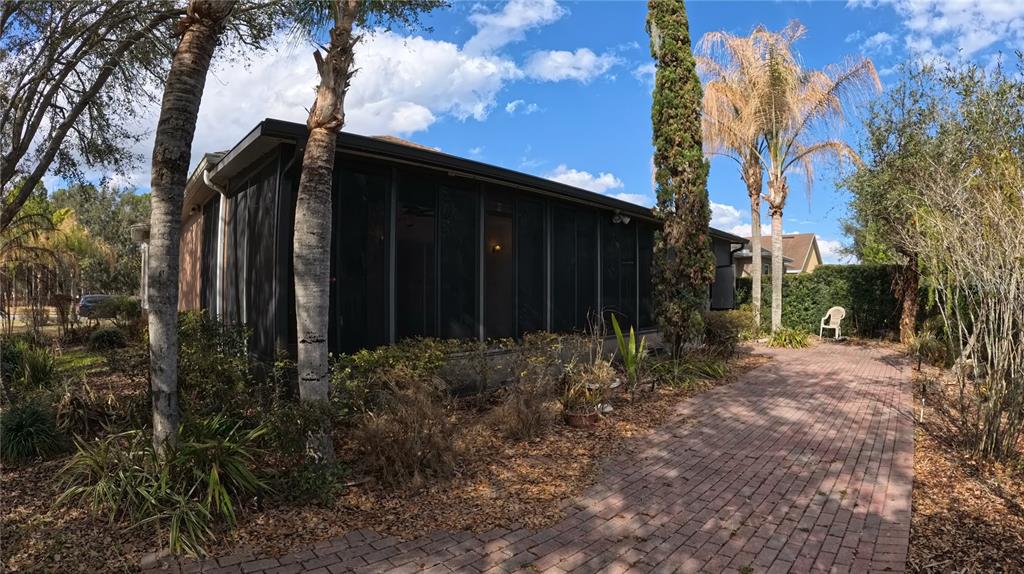 100 Flame Vine Way Groveland, FL 34736 - Photo 28 of 38 a view of a house with a large tree and wooden fence