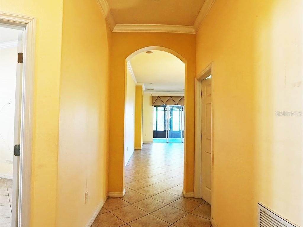 100 Flame Vine Way Groveland, FL 34736 - Photo 8 of 38 a view of a hallway with a glass door and a window
