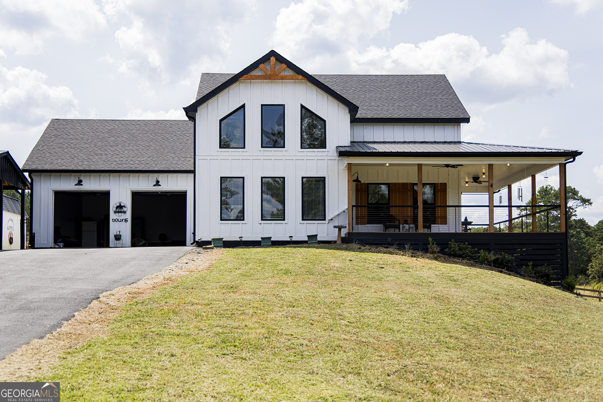a front view of a house with yard and balcony