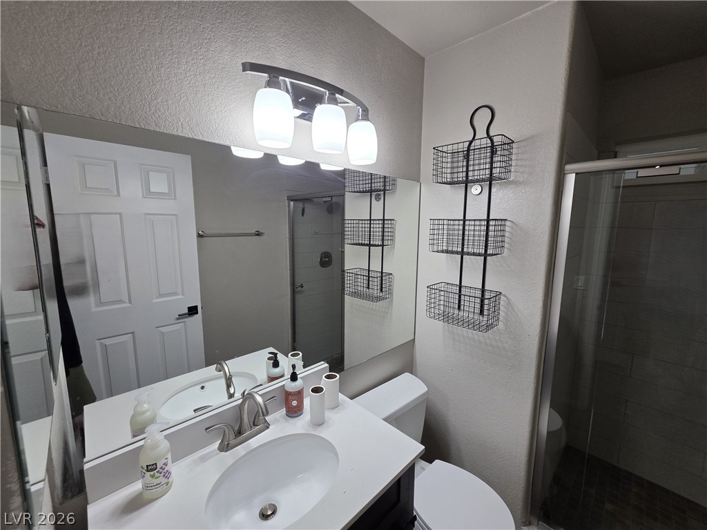2275 Ramsgate Drive Henderson, NV 89074 - Photo 81 of 84 A well-appointed bathroom features a single vanity, ample mirror space, and a sleek shower.