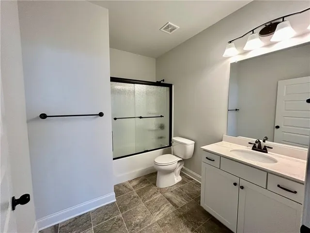a bathroom with a toilet a sink and a mirror