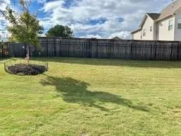 a view of a white house with a yard