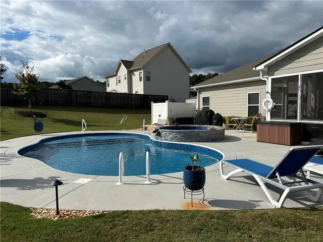 a view of a swimming pool with an outdoor space and seating area