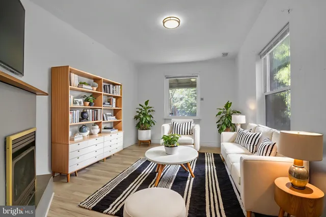 a living room with furniture and a book shelf