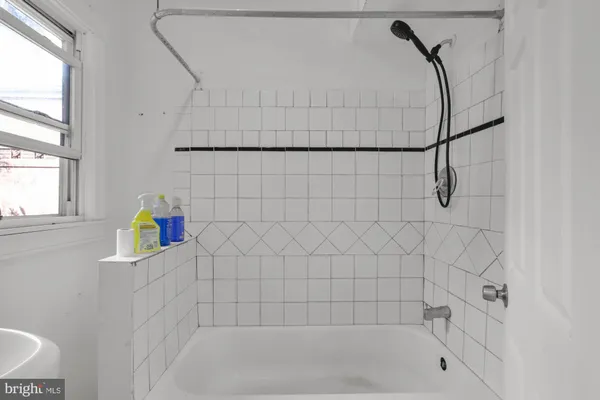 a bath room with a bath tub and a shower