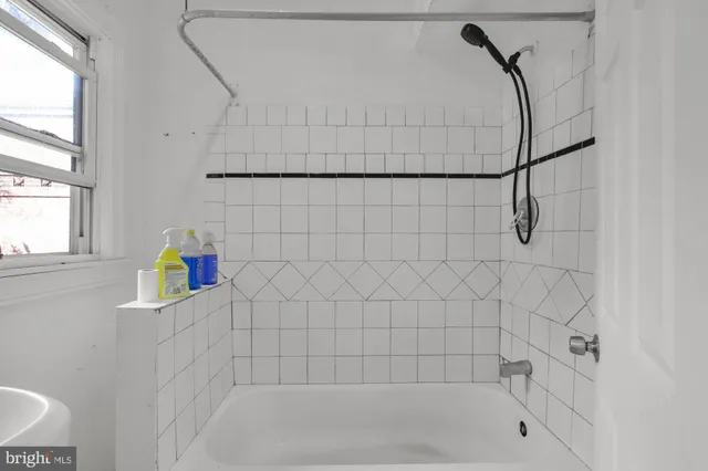 a bath room with a bath tub and a shower