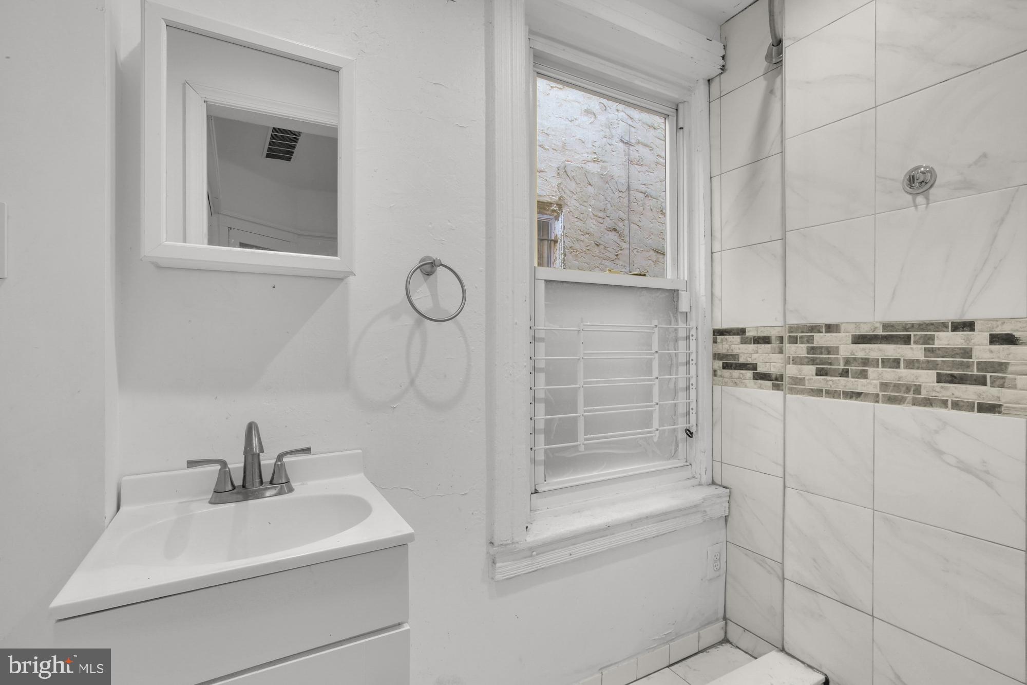 3215 Winter Street Philadelphia, PA 19104 - Photo 7 of 31 a bathroom with a sink a toilet and shower