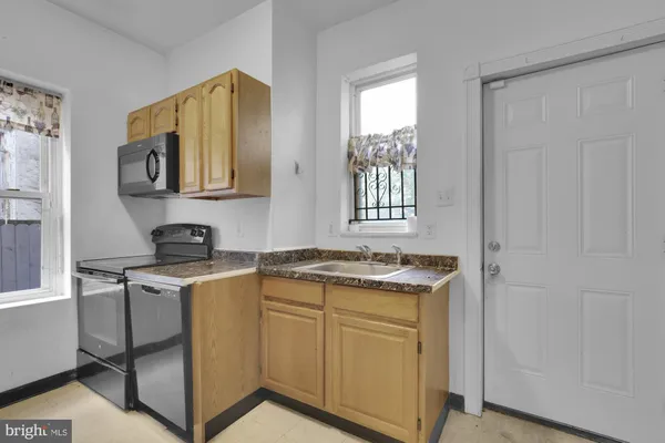 a kitchen with stainless steel appliances granite countertop a stove sink and cabinets