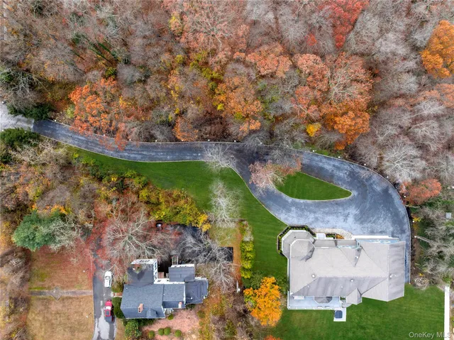 an aerial view of a house with yard swimming pool and outdoor seating