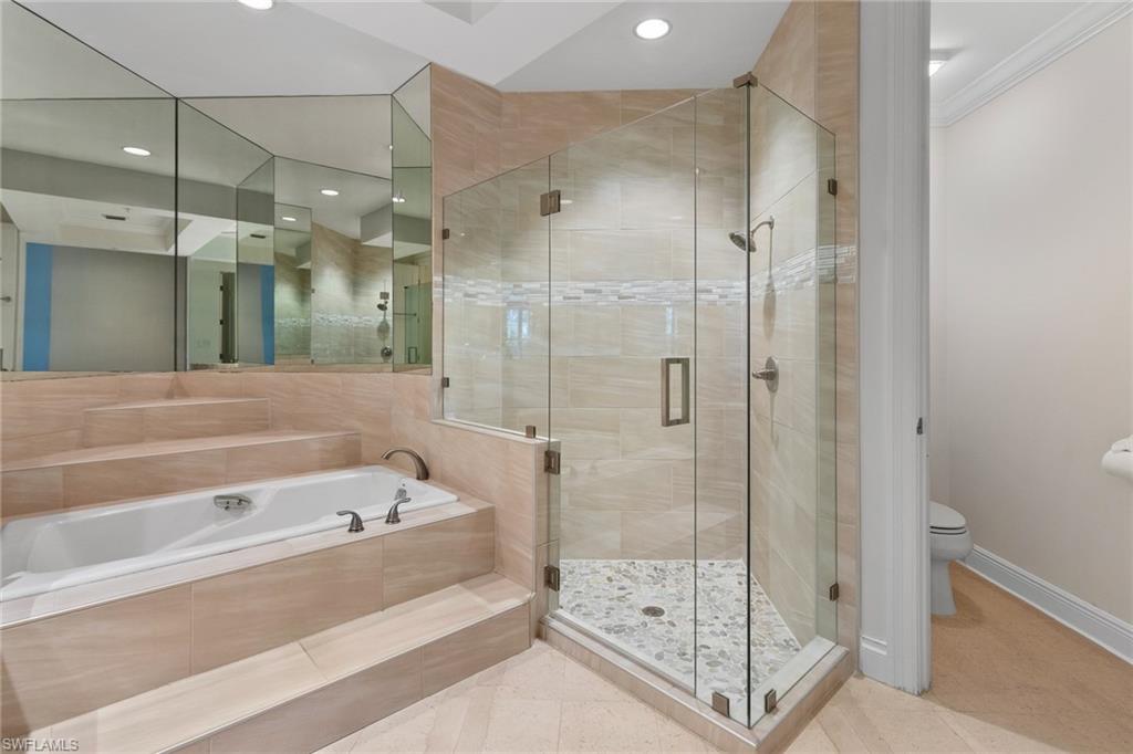 137 Colonade Circle, Unit 601 Naples, FL 34103 - Photo 11 of 28 a bathroom with a bathtub and a shower