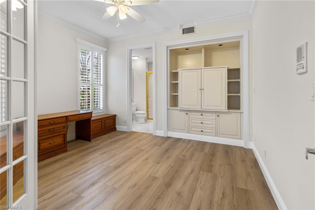 137 Colonade Circle, Unit 601 Naples, FL 34103 - Photo 14 of 28 an empty room with wooden floor and windows