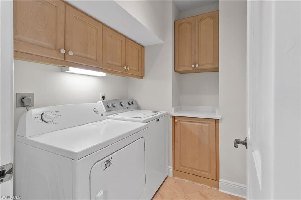 137 Colonade Circle, Unit 601 Naples, FL 34103 - Photo 18 of 28 a utility room with dryer and washer