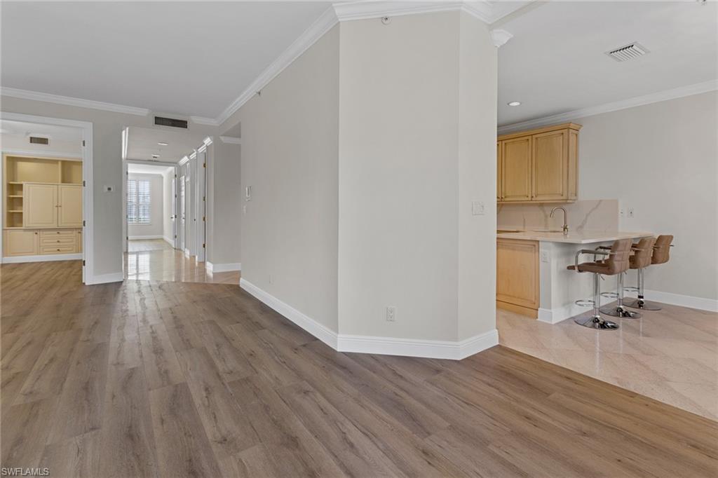137 Colonade Circle, Unit 601 Naples, FL 34103 - Photo 5 of 28 a view of workspace with wooden floor and chair