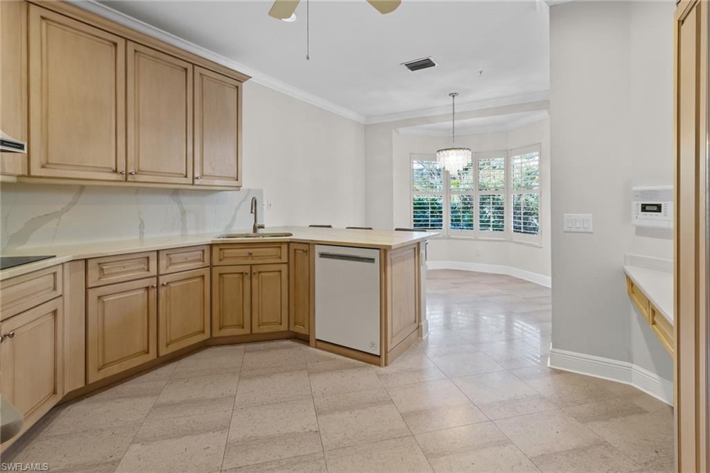 137 Colonade Circle, Unit 601 Naples, FL 34103 - Photo 8 of 28 a kitchen with a sink window and cabinets