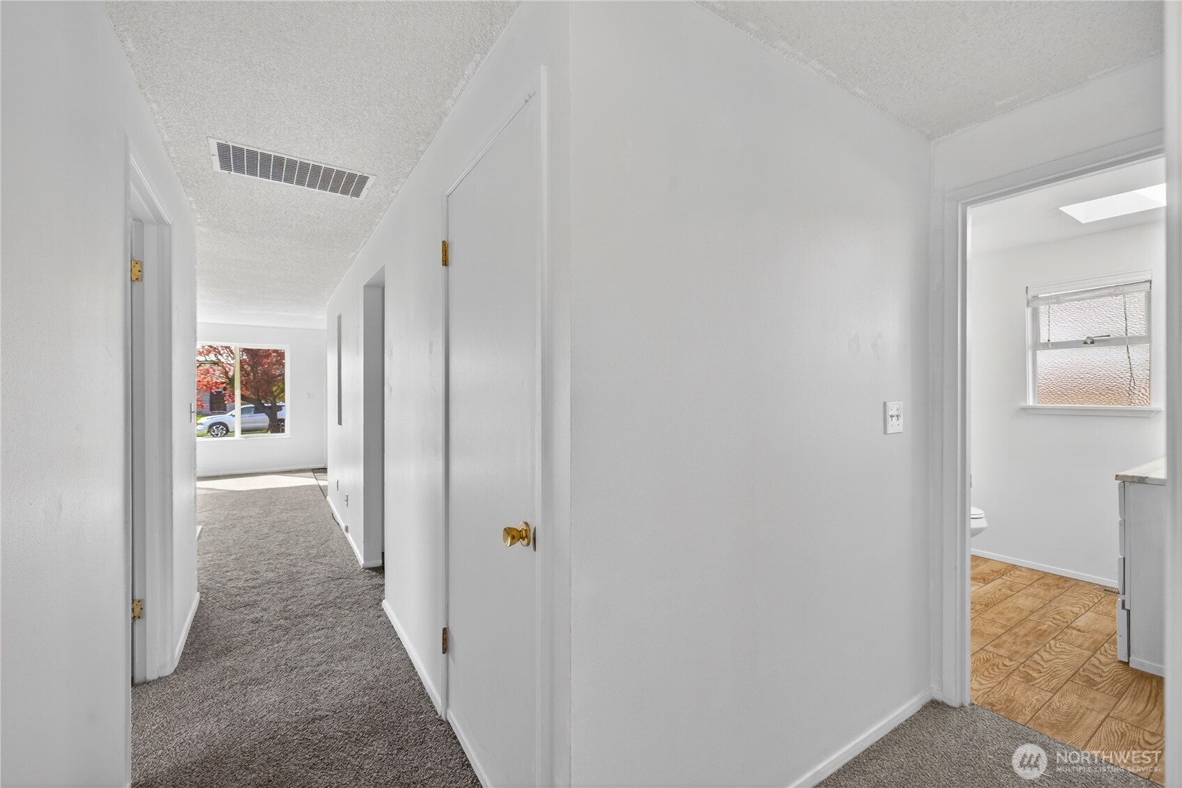 282 Southwest 10th Avenue Oak Harbor, WA 98277 - Photo 21 of 33 a view of a hallway with wooden floor and a bathroom