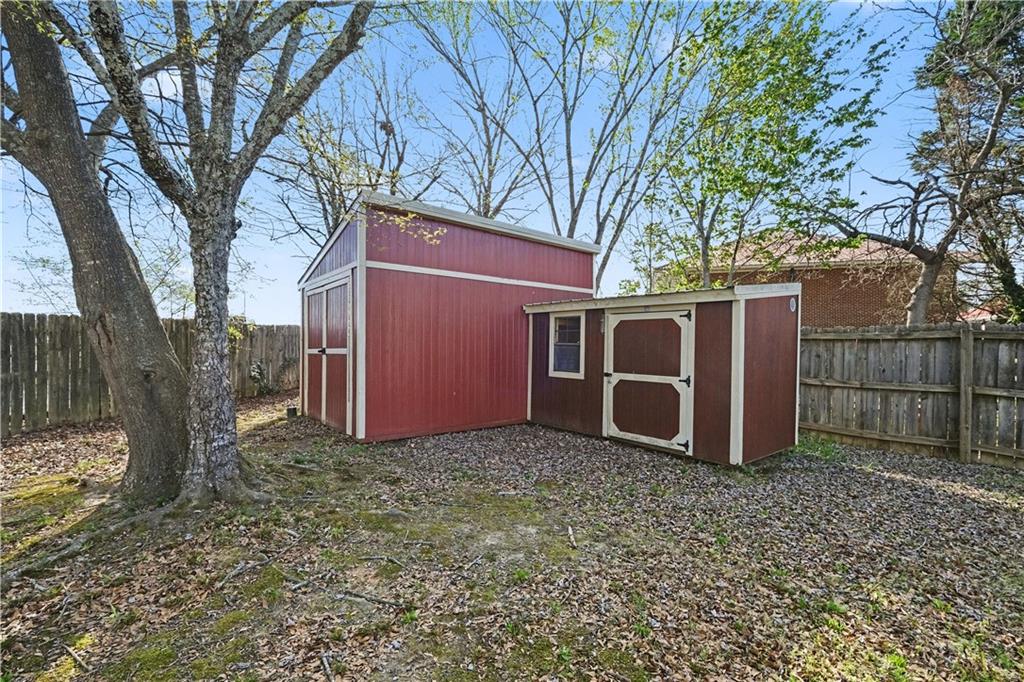 280 Courtyard Circle Winder, GA 30680 - Photo 18 of 24 a view of a house with a large tree and wooden fence