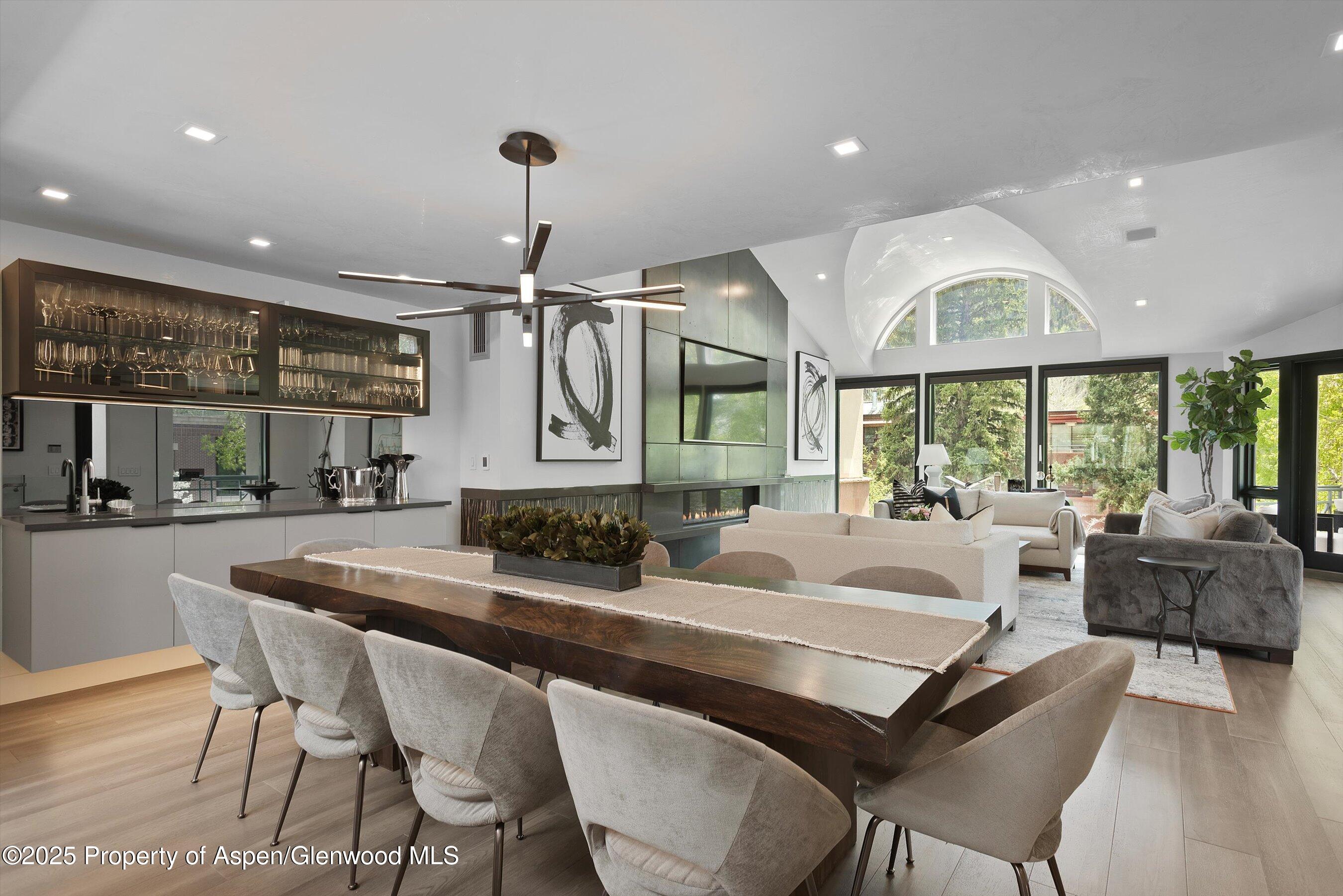 120 South Spring Street, Unit 1 Aspen, CO 81611 - Photo 12 of 37 a dining room with furniture a window and a chandelier