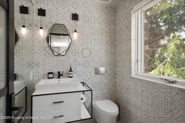a bathroom with a sink a mirror and a toilet