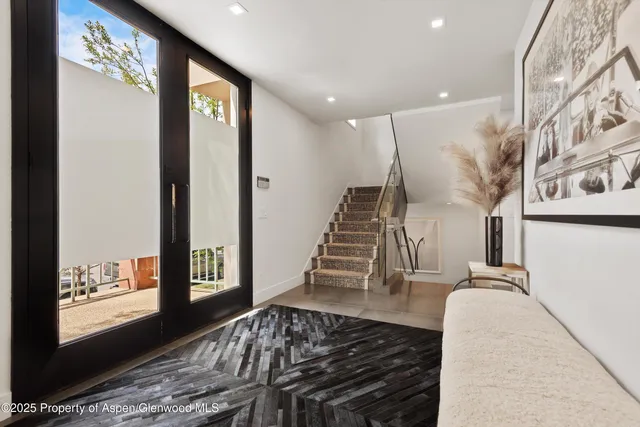 a view of entryway and hall with wooden floor