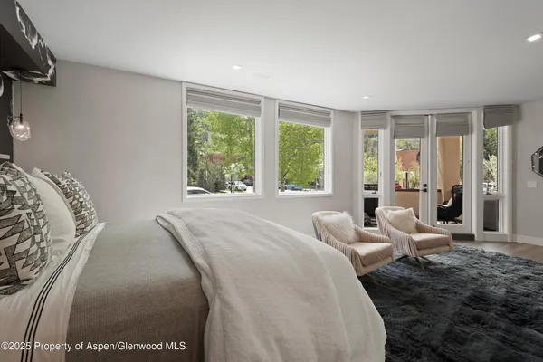 a bedroom with a bed and glass windows